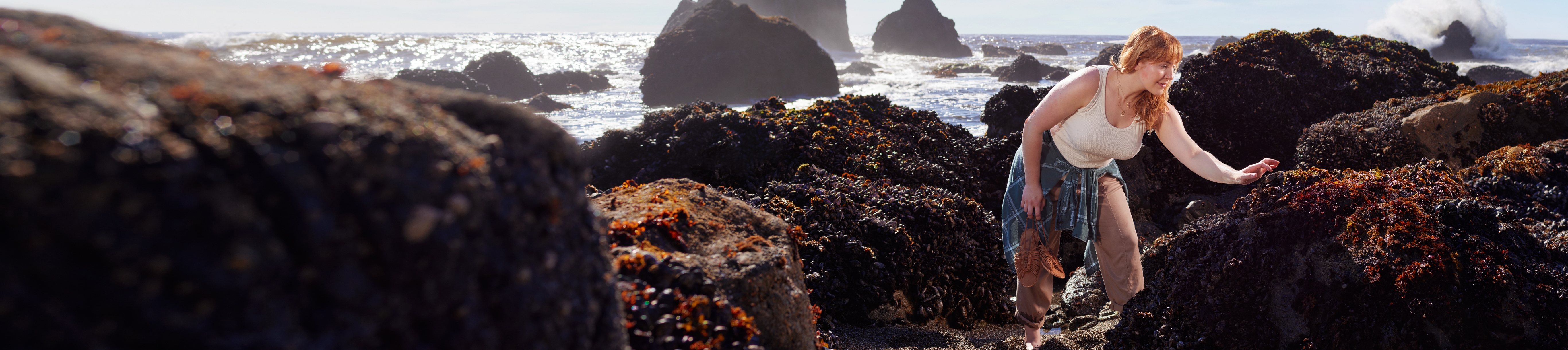 Woman exploring rocky shore